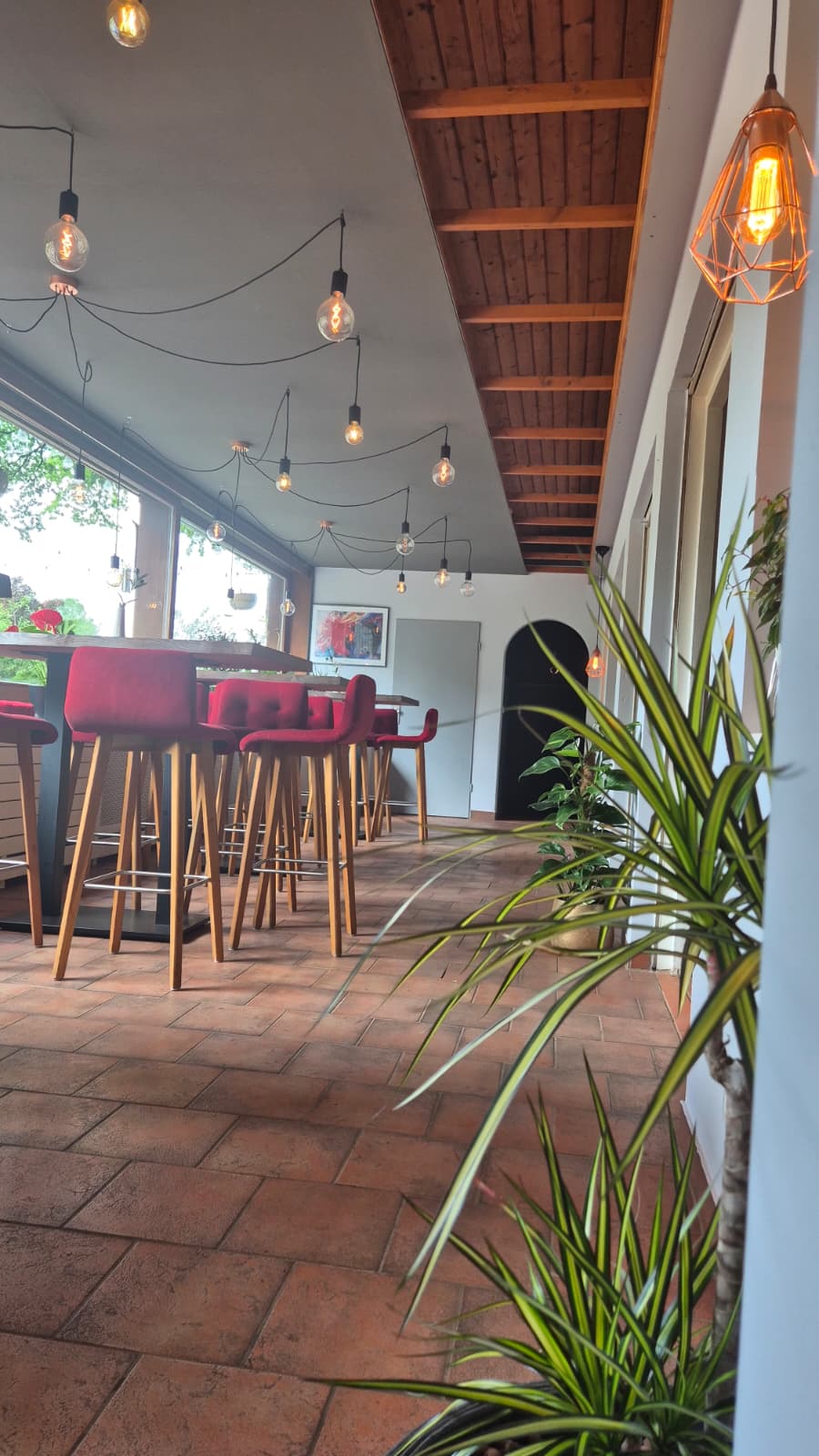 Modernes Interieur mit roten Sesseln und Pendelleuchten
